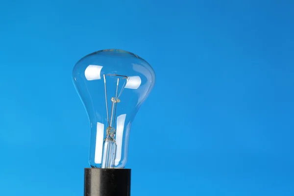 Light bulb on blue — Stock Photo, Image