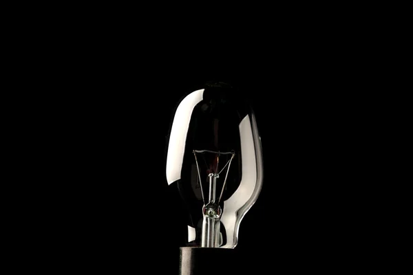 Лампочка ізольована на чорному — стокове фото