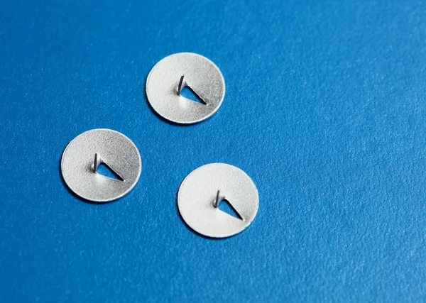 Three tacks on blue — Stock Photo, Image