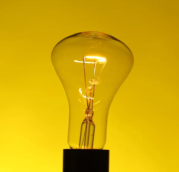 Light bulb on yellow — Stock Photo, Image