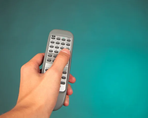 Hand holding a remote control — Stock Photo, Image
