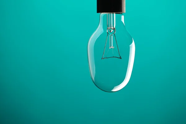 Light bulb on blue — Stock Photo, Image