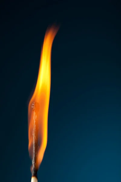 stock image Burning match with tongue of flame on blue