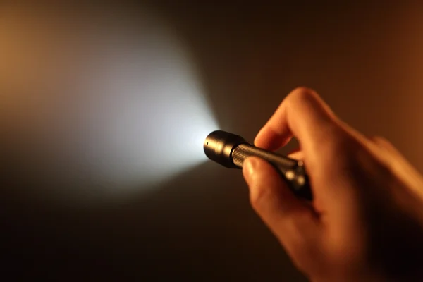 Hand holding pocket flashlight — Stock Photo, Image