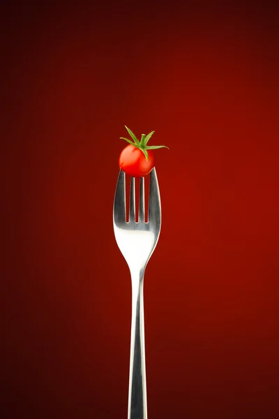 Fork with cherry tomato — Stock Photo, Image