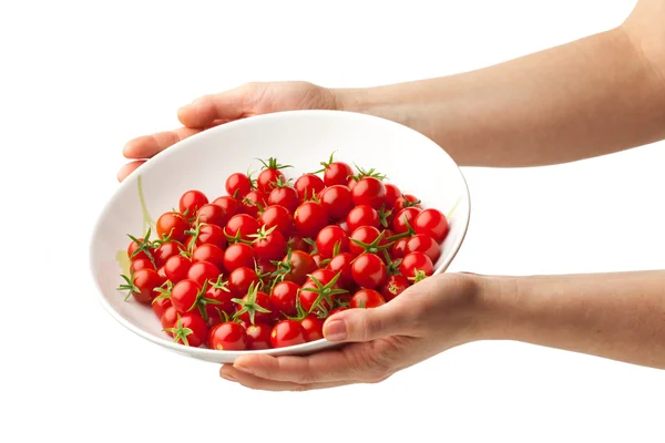 Placa de mão com tomate cereja fresco — Fotografia de Stock