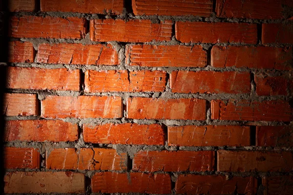 Spot ışığı ile aydınlatılan yaşlı tuğla duvar — Stok fotoğraf