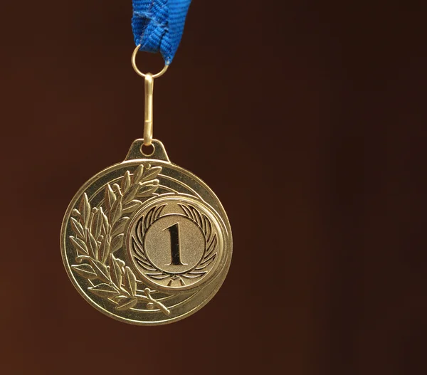 stock image Gold medal on brown background