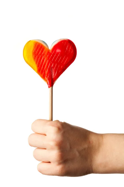 Hand holding candy heart isolated on white — Stock Photo, Image