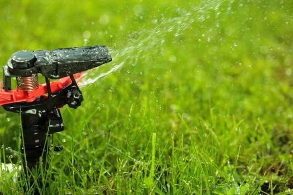 Closeup of lawn sprinkler with copyspace — Stock Photo, Image