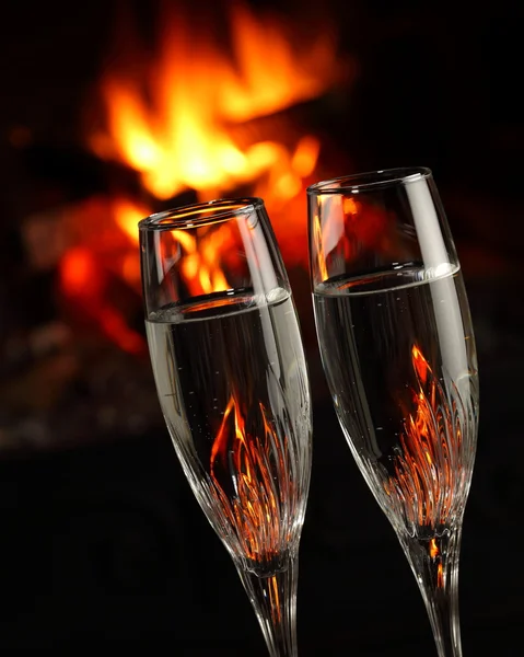 Glasses with alcohol in front of fireplace, closeup — Stock Photo, Image