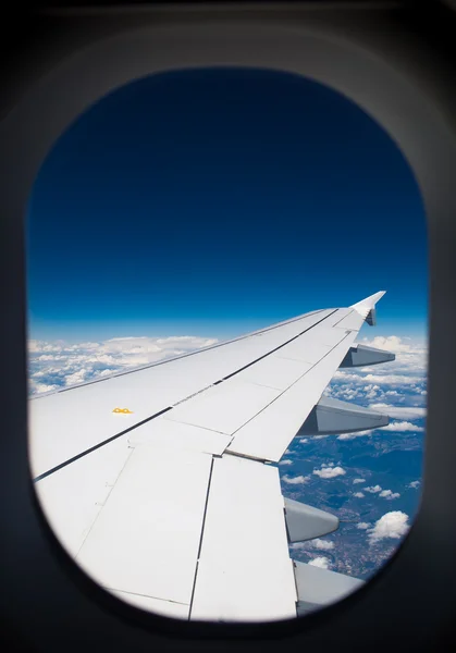 Wing of airplane - view through the window — Stock Photo, Image