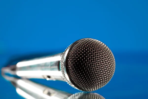 Micrófono contra el fondo azul — Foto de Stock