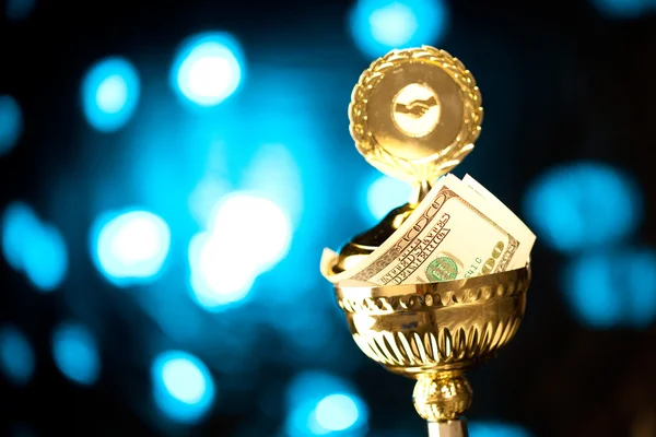 Gold cup with money — Stock Photo, Image