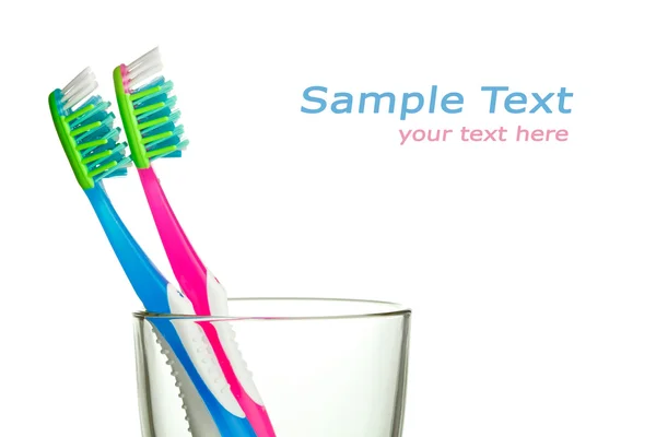 stock image Two toothbrushes in the glass with copy-space