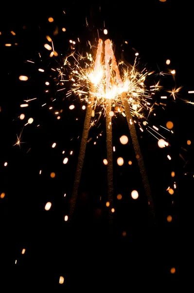 Yellow sparkler with fire particles — Stock Photo, Image