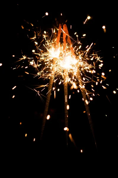 Yellow sparkler with fire particles — Stock Photo, Image