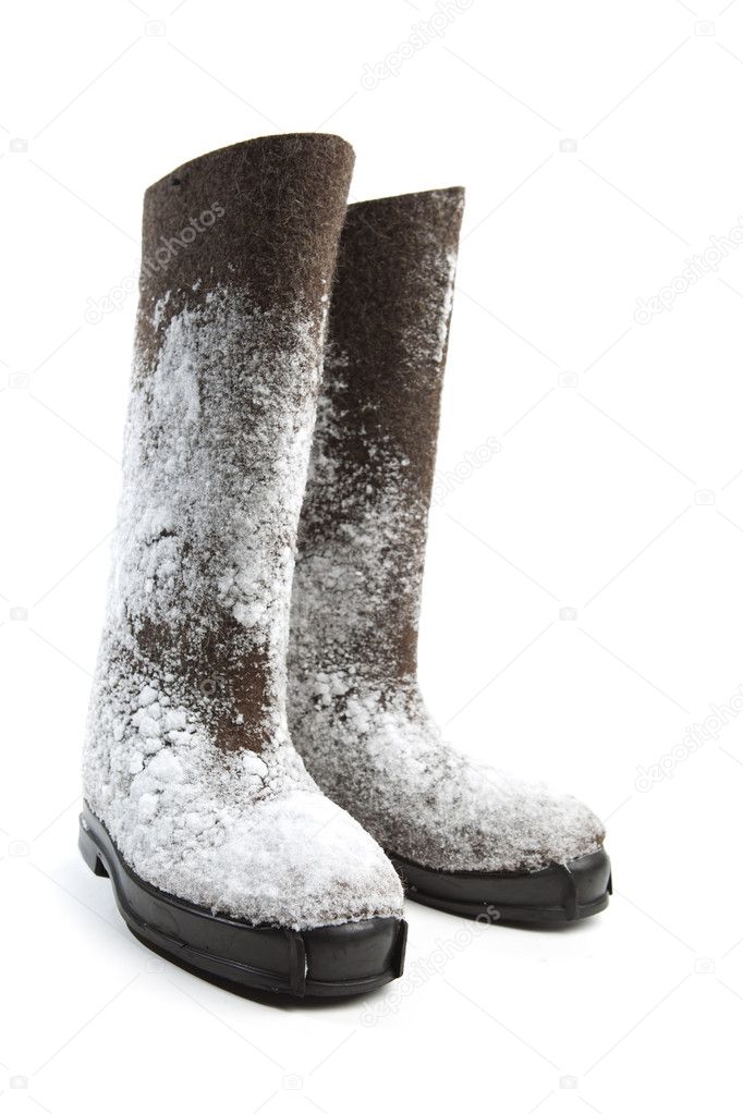 Felt boots with snow isolated on white