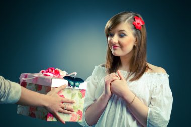 Attractive young woman receives a gift clipart