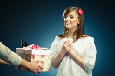 Beautiful young woman recieves a gift clipart