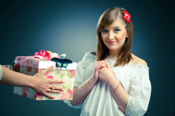 Beautiful young woman receives a gift — Stock Photo, Image