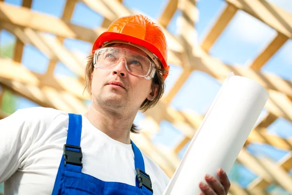 Worker looking at the construction project — Stock Photo, Image