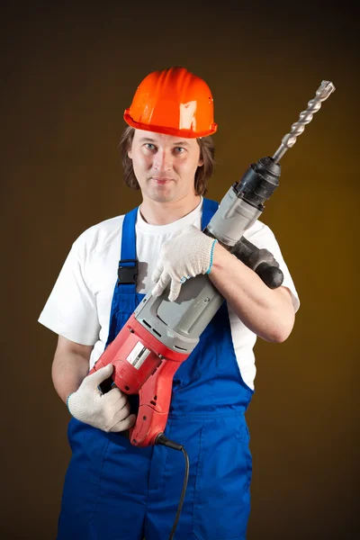 Worker holding a machine drill — Stockfoto