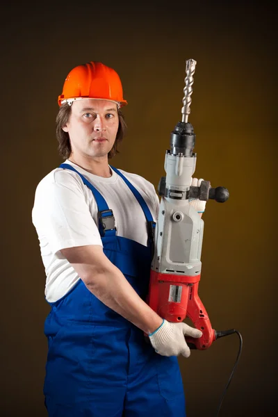Trabajador sosteniendo un taladro de máquina —  Fotos de Stock