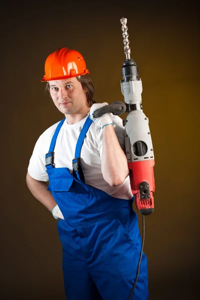 Worker holding a machine drill — Stockfoto