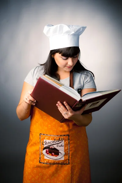 Woman cook reading recipes — Stock Photo, Image