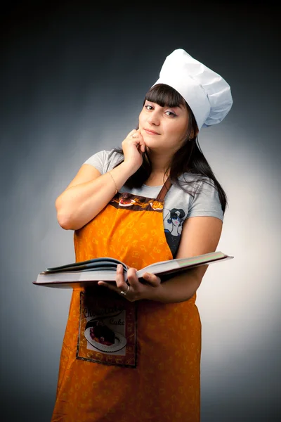Woman cook holding a recipes book — Stock Photo, Image