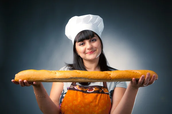 Woman cook holding fresh bread — Stock Photo, Image