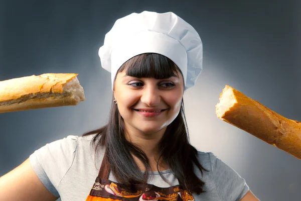 Woman cook with breaked french bread — Stock Photo, Image