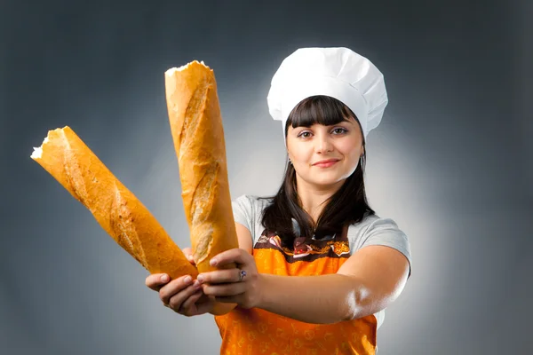 Woman cook holding breaked french bread — Stock Photo, Image