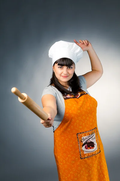 Woman cook fencing with rolling pin — Stock Photo, Image