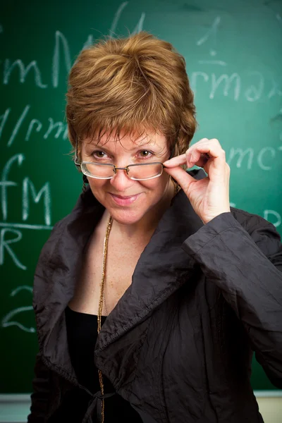 stock image Smiling teacher holding glasses