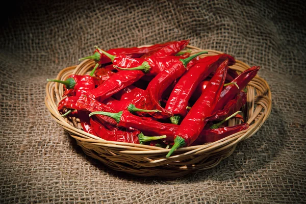 Chili peppers on the wicker dish — Stock Photo, Image