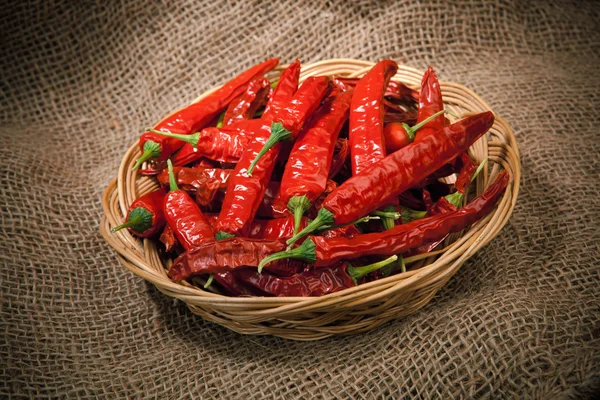 Chili peppers on the wicker dish — Stock Photo, Image