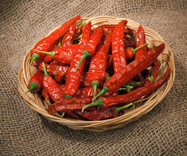 Red chili peppers on the wicker dish — Stock Photo, Image