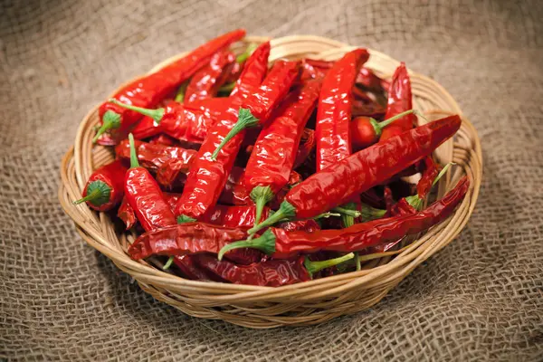 Red chili peppers on the wicker dish — Stock Photo, Image