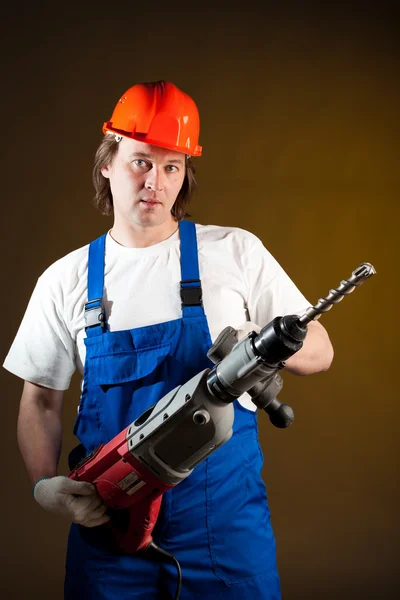 Worker holding a machine drill Stock Photo
