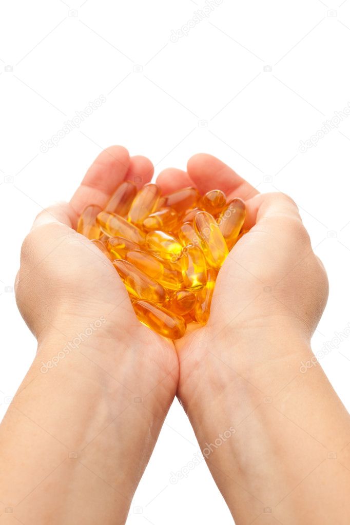 Hands holding omega-3 fish fat oil capsules