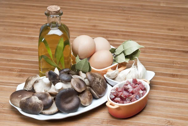 stock image Mushrooms, eggs, ham and olive oil to cook.