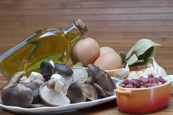 stock image Mushrooms, eggs, ham and olive oil to cook.