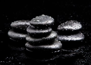 Spa Stones. black shiny zen stones with water drops over black b clipart