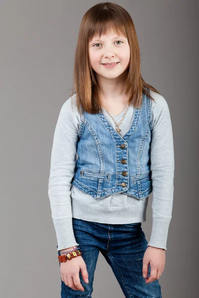 Young happy girl. little girl on a gray background. Happy chil — Stock Photo, Image
