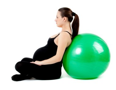Pregnant woman excercises with gymnastic ball. Beautiful pregnan clipart