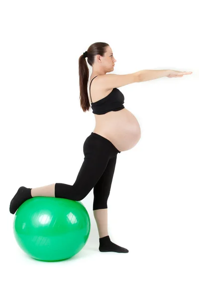 Beautiful pregnant woman sitting with exercise bal. Isolated on — Stock Photo, Image