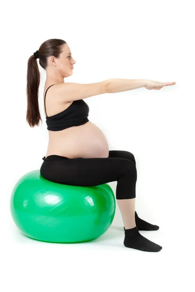 Bella donna incinta seduta con esercizio a base di erbe. Isolato il — Foto Stock