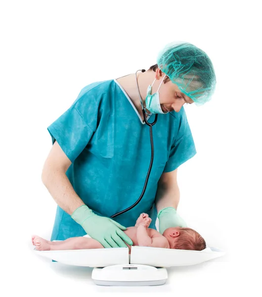 stock image Doctor and baby on a white background. Little baby on scales.